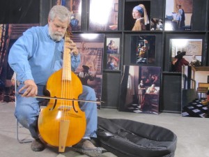 Tim Jenison tries out the viola da gamba that is part of Vermeer's 'The Music Lesson.'