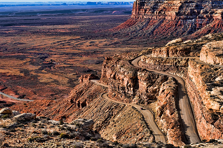 winding road cuts through red rock