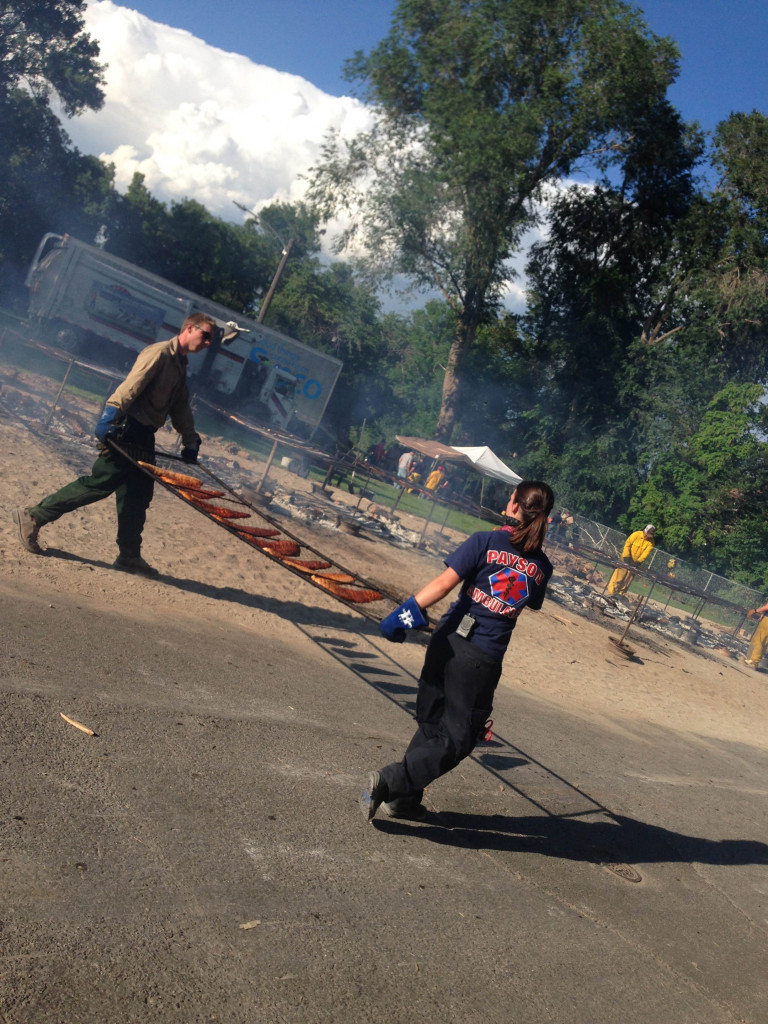 firefighters and ambulance workers cooking salmon